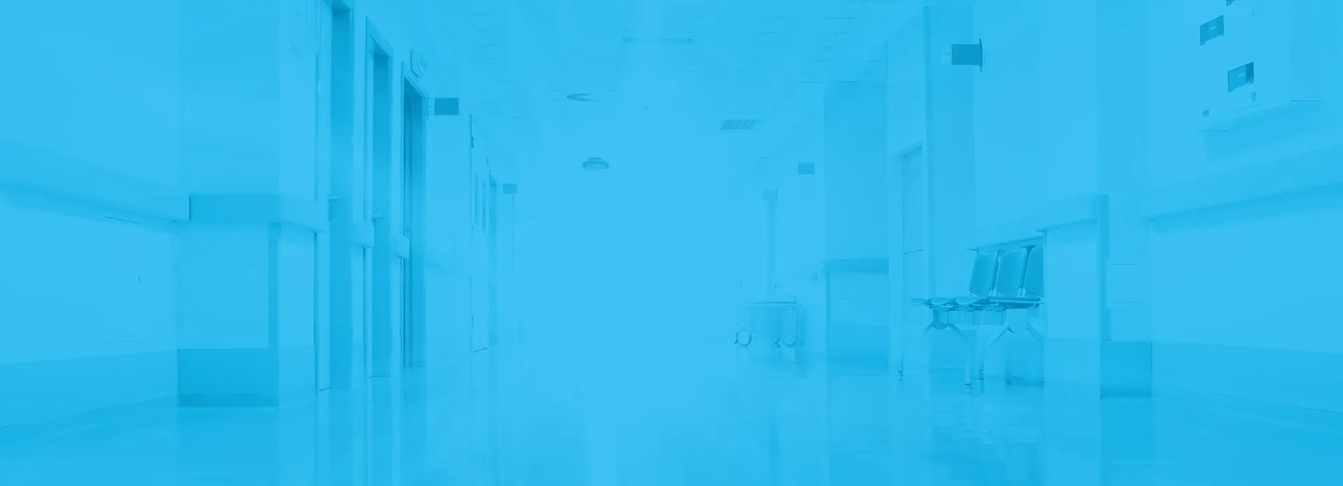 Hospital hallway with doors and ceiling lights, tinted blue